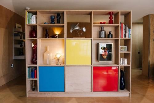 uma estante de livros com muitas portas coloridas diferentes em Seahorse Studio, Aldeburgh em Aldeburgh