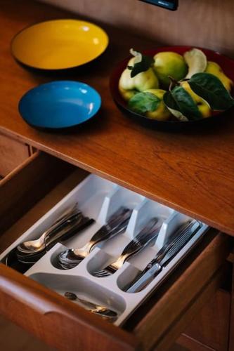 a drawer filled with utensils and a bowl of fruit at Seahorse Studio, Aldeburgh in Aldeburgh
