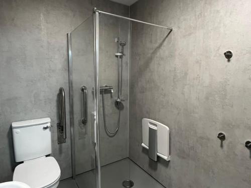 a bathroom with a shower stall with a toilet at Seahorse Studio, Aldeburgh in Aldeburgh