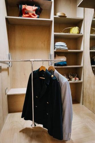 a walkin closet with a black shirt hanging on a rack at Seahorse Studio, Aldeburgh in Aldeburgh
