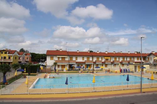 a large swimming pool in front of a building at Enjoy your stay in our nice flat with pool in Rosapineta