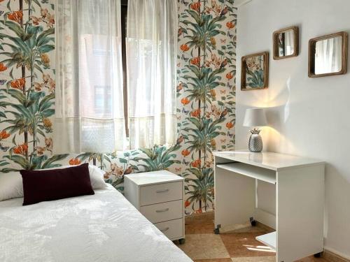 科爾多瓦的住宿－Coqueto apartamento estación，一间卧室配有一张床、一张书桌和一个窗户。