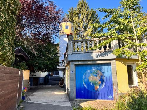 a building with a blue garage door with a painting of a globe at W.I.P. Welt im Park in Dresden