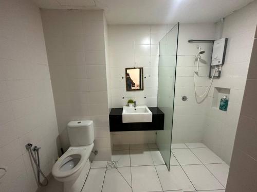 a bathroom with a toilet and a sink and a shower at NH Homestay Trefoil Setia Alam in Shah Alam