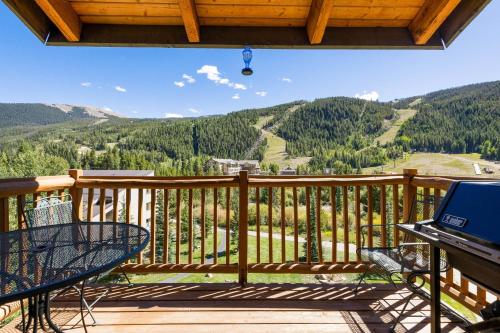 a balcony with a table and a view of a mountain at 2674 Tenderfoot Lodge Condo in Keystone