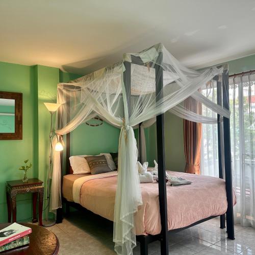 a bedroom with a bed with a canopy at Awana House in Chiang Mai