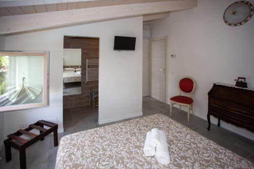 a bedroom with a bed and a desk and a piano at b&b RetrO'Conero in Castelfidardo