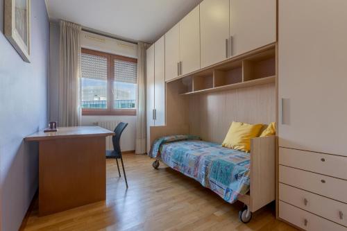 a bedroom with a bed and a desk and a desk at Parco del Velodromo Comfortable Apartment in Bologna