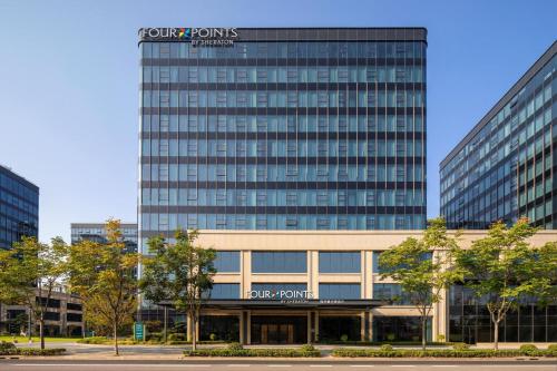 a tall building with a sign on top of it at Four Points by Sheraton Shanghai Hongqiao in Shanghai