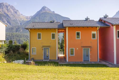 a row of houses with mountains in the background at Arch San Martin C in Scuol