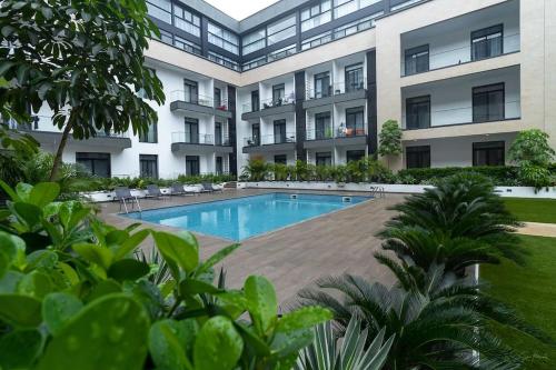 a swimming pool in front of a building at Family 3 Bed Loft @Cantonments in Cantonments