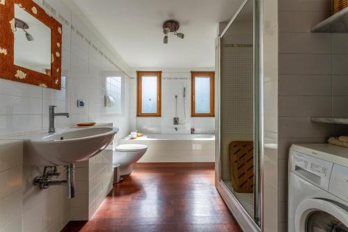 a bathroom with a sink and a washing machine at Belvedere, House With Pool- Recco, Liguria 