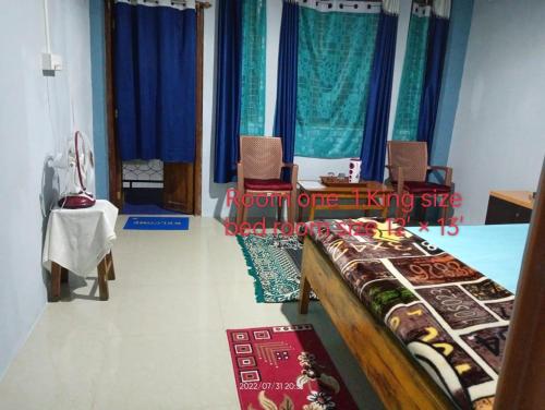 a room with chairs and a table with food on it at VIbe n Joy Homestay in Cherrapunji