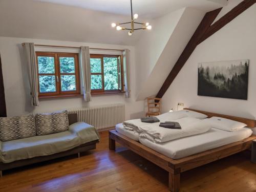 1 dormitorio con 1 cama y 1 silla en Haus 2 Hanselishof - 2 Wohnungen, en Schenkenzell