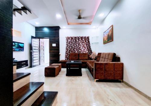 a living room with a couch and a table at Staeg Villa in the Center of the City 2BHK in Indore