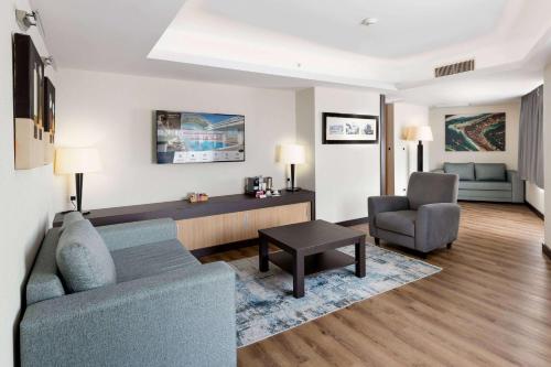 a living room with a couch and a chair at Ramada Plaza By Wyndham Istanbul City Center in Istanbul