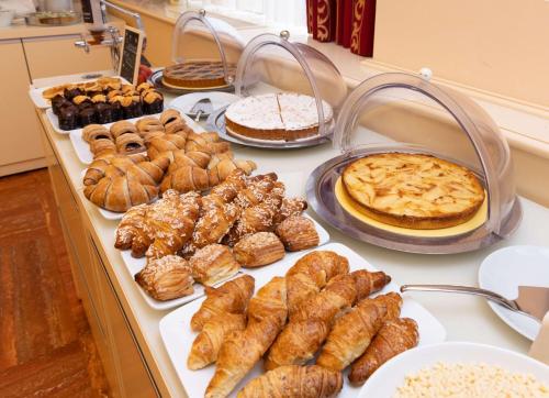 a buffet of different types of pastries and pies at Best Western Gorizia Palace in Gorizia