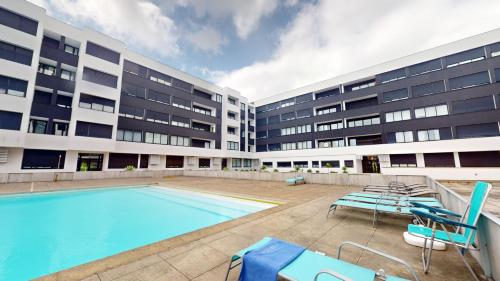 a swimming pool in front of a building at Azores Pico Salomão T4 Apartment - Super Spacious in Ponta Delgada