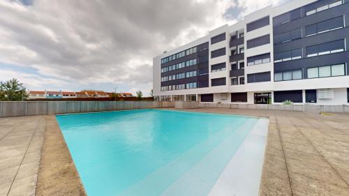 a swimming pool in front of a building at Azores Pico Salomão T4 Apartment - Super Spacious in Ponta Delgada