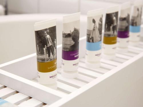 a shelf with a row of sunscreen bottles on it at Mercure Sheffield Parkway in Sheffield