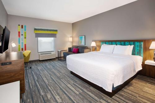 a hotel room with a bed and a flat screen tv at Hampton Inn & Suites Lady Lake/The Villages in The Villages