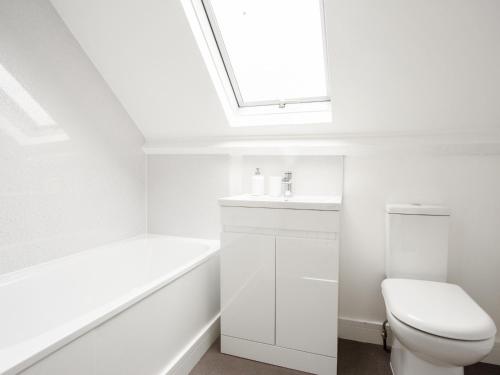 La salle de bains est pourvue de toilettes, d'un lavabo et d'une lucarne. dans l'établissement Large Modern Family Home Windsor, à Windsor