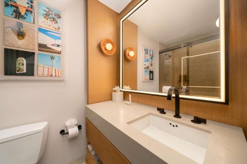a bathroom with a sink and a mirror at Hilton San Diego Gaslamp Quarter in San Diego