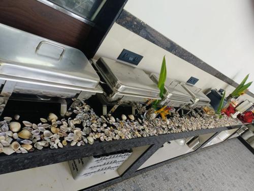 a kitchen counter with a bunch of rocks and pans at UVA Sands Beach Resort in Kundapur