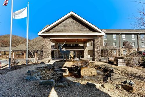 a building with a statue of a goat in front of a fountain at La Quinta by Wyndham Boone in Boone