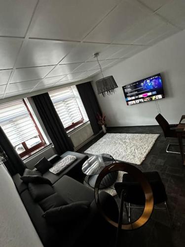 a living room with a couch and a tv at Schöne Wohnung in Bestlage inclusive Parkplatz in Leipzig