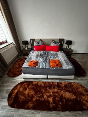 a bedroom with a bed with two rugs on it at Schöne Wohnung in Bestlage inclusive Parkplatz in Leipzig