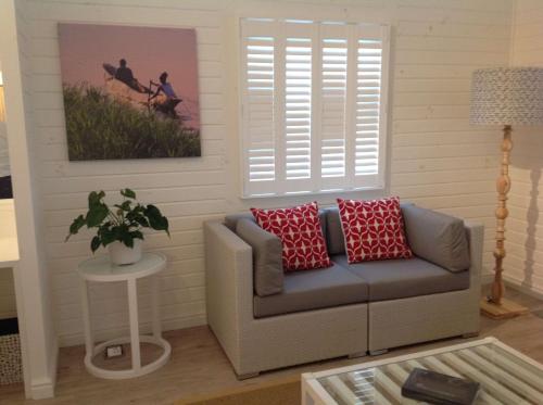 a living room with a couch and a picture at Tete Ferry Sun in Vila-de-Santiago-Maior