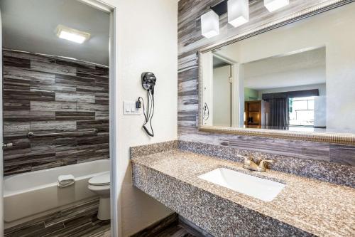 a bathroom with a sink and a mirror at Quality Inn & Suites Downtown in Orlando