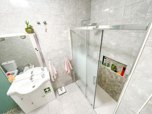 a bathroom with a shower and a sink at Lisbon at your Doorstep - Bedrooms in Lisbon