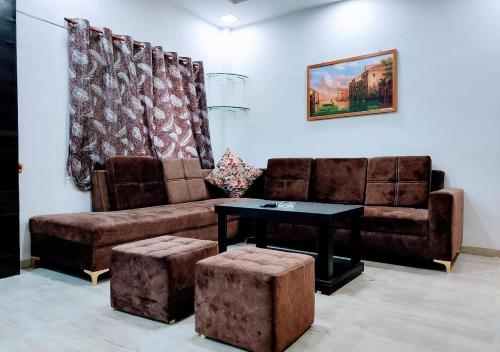 a living room with a couch and a table at Staeg Villa in the Center of the City 2BHK in Indore