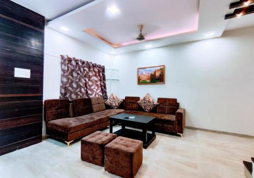 a living room with a couch and a table at Staeg Villa in the Center of the City 2BHK in Indore