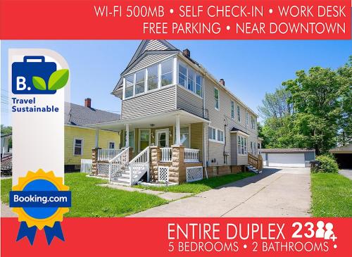 a house with a sign that reads elite duplex at The Rubi Lounge - Spacious Brooklyn Centre Modern Escape Near Downtown With Parking, 300MB WiFi & Self Check-In in Cleveland