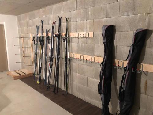 a bunch of hockey bats hanging on a wall at Chata Dorotka Kvilda in Kvilda