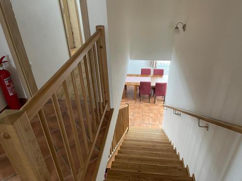 a staircase leading up to a room with a table at Chata Dorotka Kvilda in Kvilda