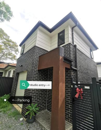 a house with a large cross on the side of it at Ermihome Studio in Sydney