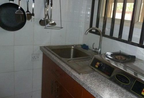 uma cozinha com um lavatório e uma bancada em Room in Lodge - Vision Serviced Apartments em Asaba