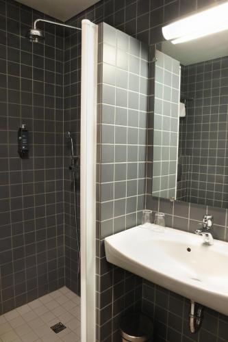 a bathroom with a sink and a mirror at Hotel Reykjavík Centrum in Reykjavík