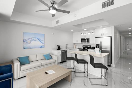 a living room with a couch and a table at Ocean Club Treasure Island Hotel in St Pete Beach