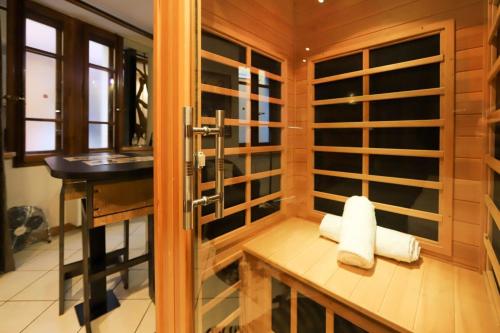 a bathroom with a shower with towels on a bench at Le Cocon - Lofts & Lakes certified 4-stars in Annecy