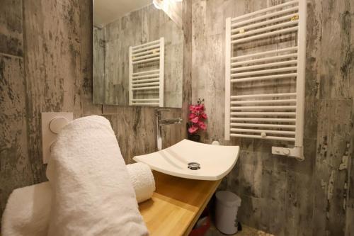 a bathroom with a white sink and a mirror at Le Cocon - Lofts & Lakes certified 4-stars in Annecy