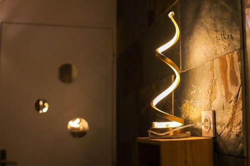 a lit up lamp on a table in a room at Le Cocon - Lofts & Lakes certified 4-stars in Annecy