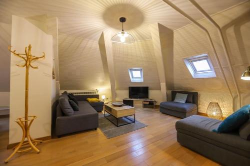 a living room with two couches and a tv at Le Factory Duplex en vieille ville côté lac in Annecy