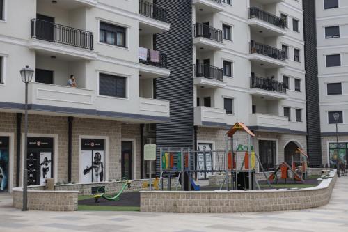 a playground in front of a apartment building at Apartman Herc in Trebinje
