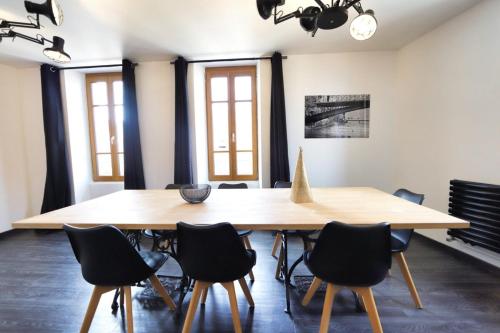 a dining room with a wooden table and chairs at 2 bd apartment with sauna in the center of Annecy in Annecy
