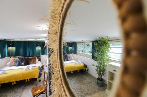 een slaapkamer met 2 bedden en een spiegel bij Chez Maminou - 8 couchages parking proche centre in Annecy